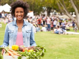 Woman holding basket of vegetables